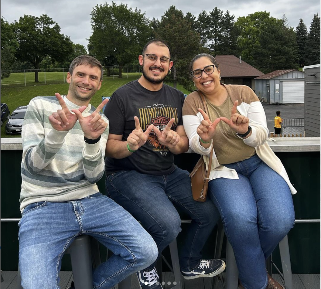 Scholars posing with their hands in 